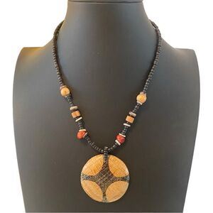 Tribal Looking Wood Pendant on Brown Beaded Chain.